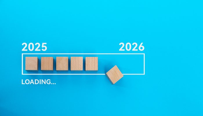 Loading bar with wooden blocks 2025 to 2026 on blue background