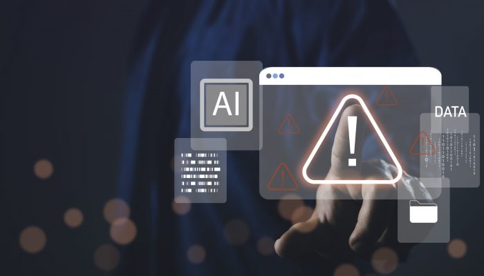 Hand pointing at digital warning icon with AI and data interface, representing system warning alert, cybersecurity threat, data error, and artificial intelligence risk.